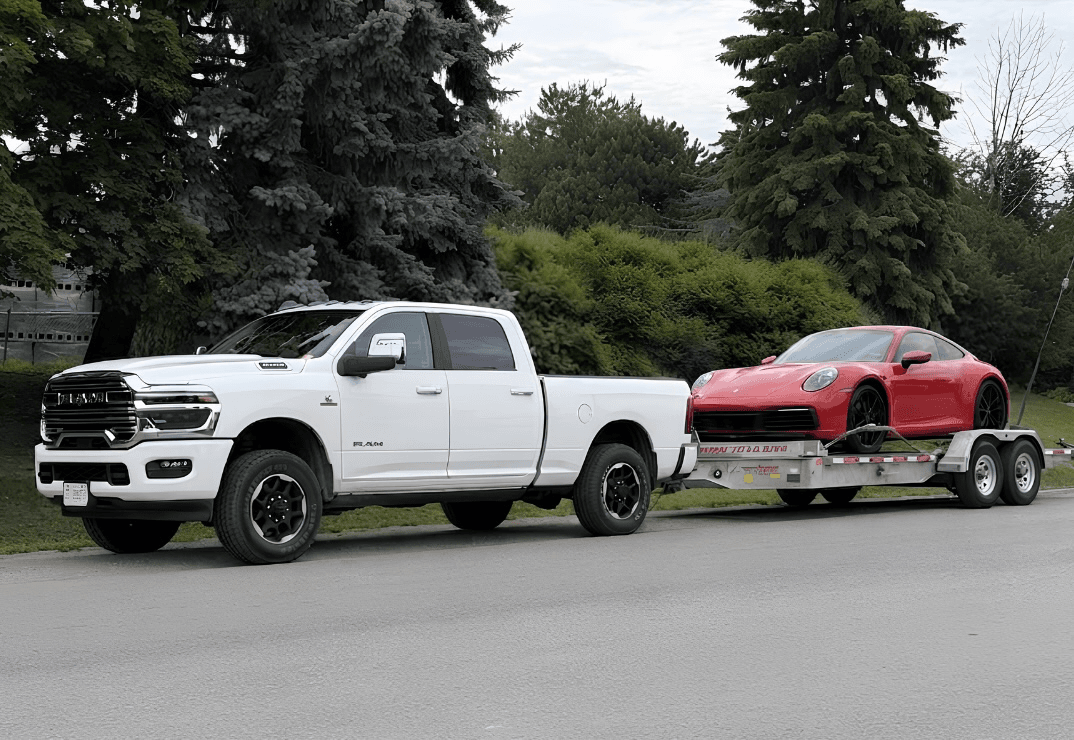 Tow truck transporting sold old car through the desert